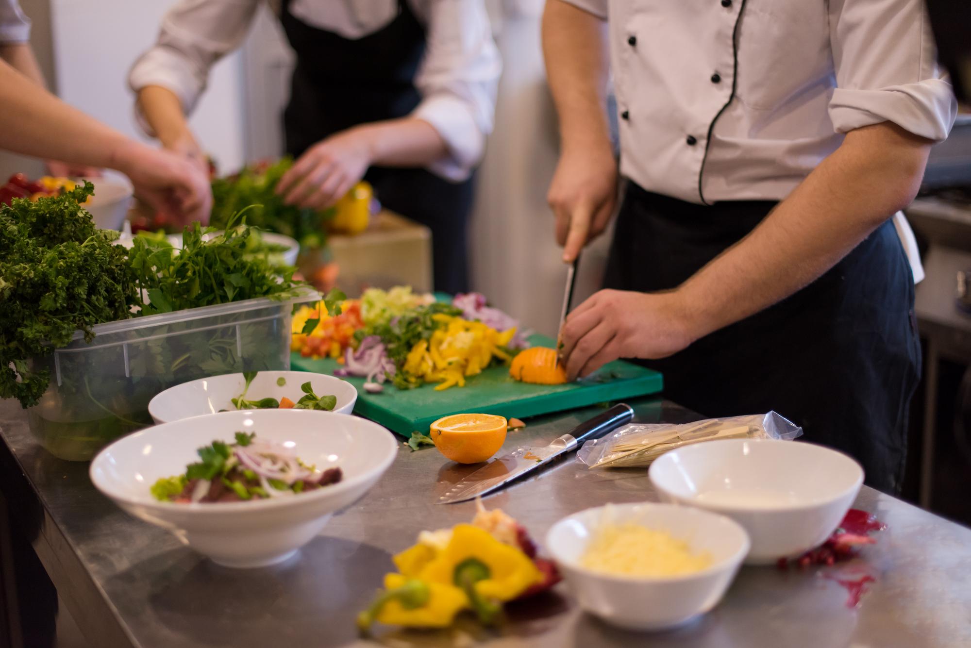 team preparing plated meals in workshop