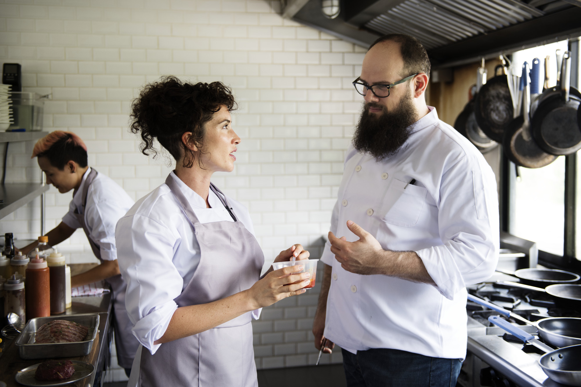 chefs discussing plating at counter